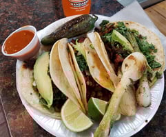 El Jarochito Tacos with hot sauce and jarrito