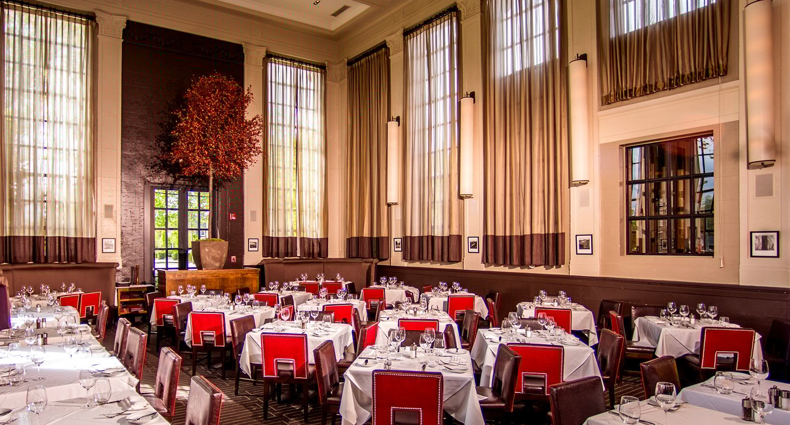 Tellers chophouse interior with seating and large floor to ceiling windows