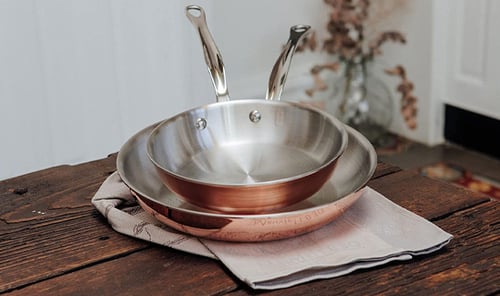 mauviel-copper-pans-stacked-on-a-table
