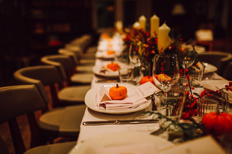 Fall themed restaurant setting with long table and chairs