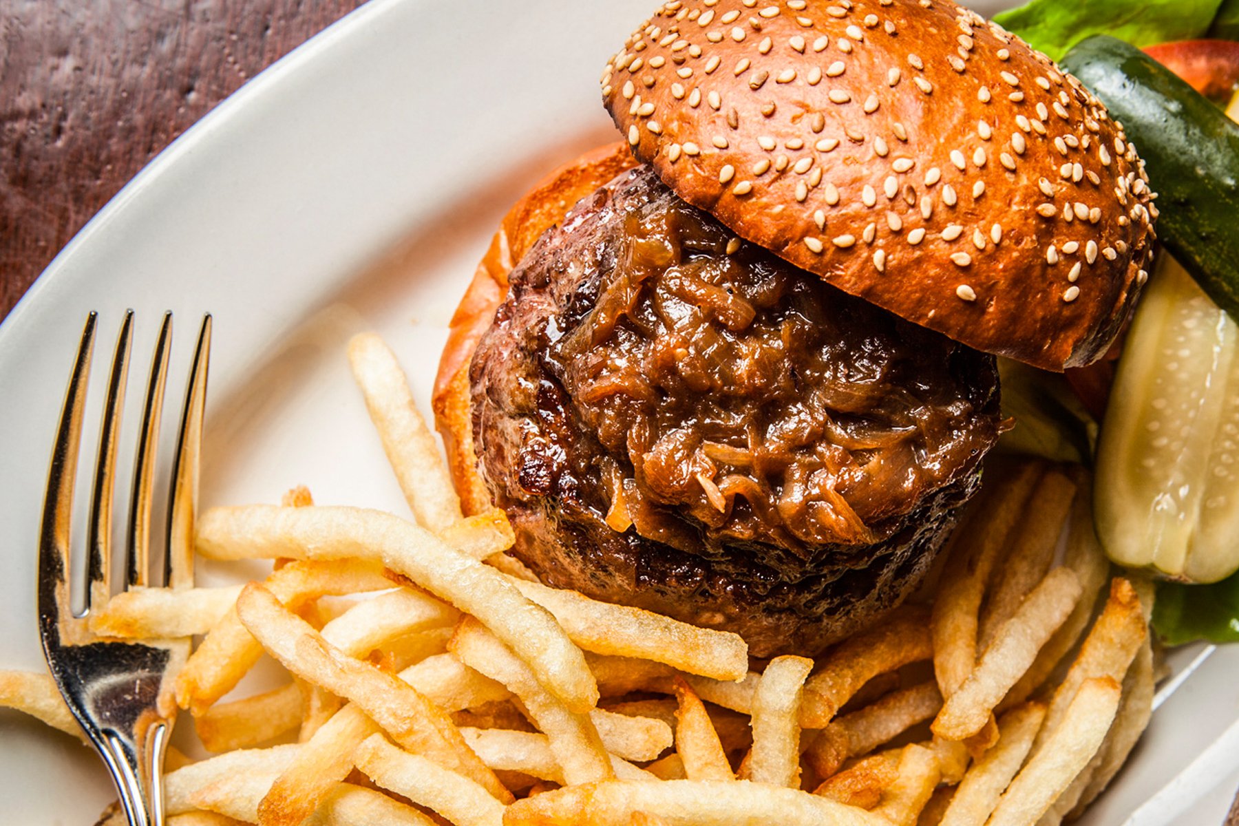 The Black Label Burger, a $33 masterpiece, is an assemblage of dry-aged rib eye, skirt steak, and brisket, courtesy of the renowned Pat La Frieda meat company.