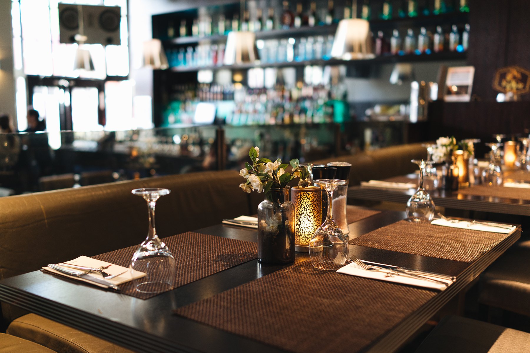 Fine dining restaurant tables and placemats with upside down wine glasses