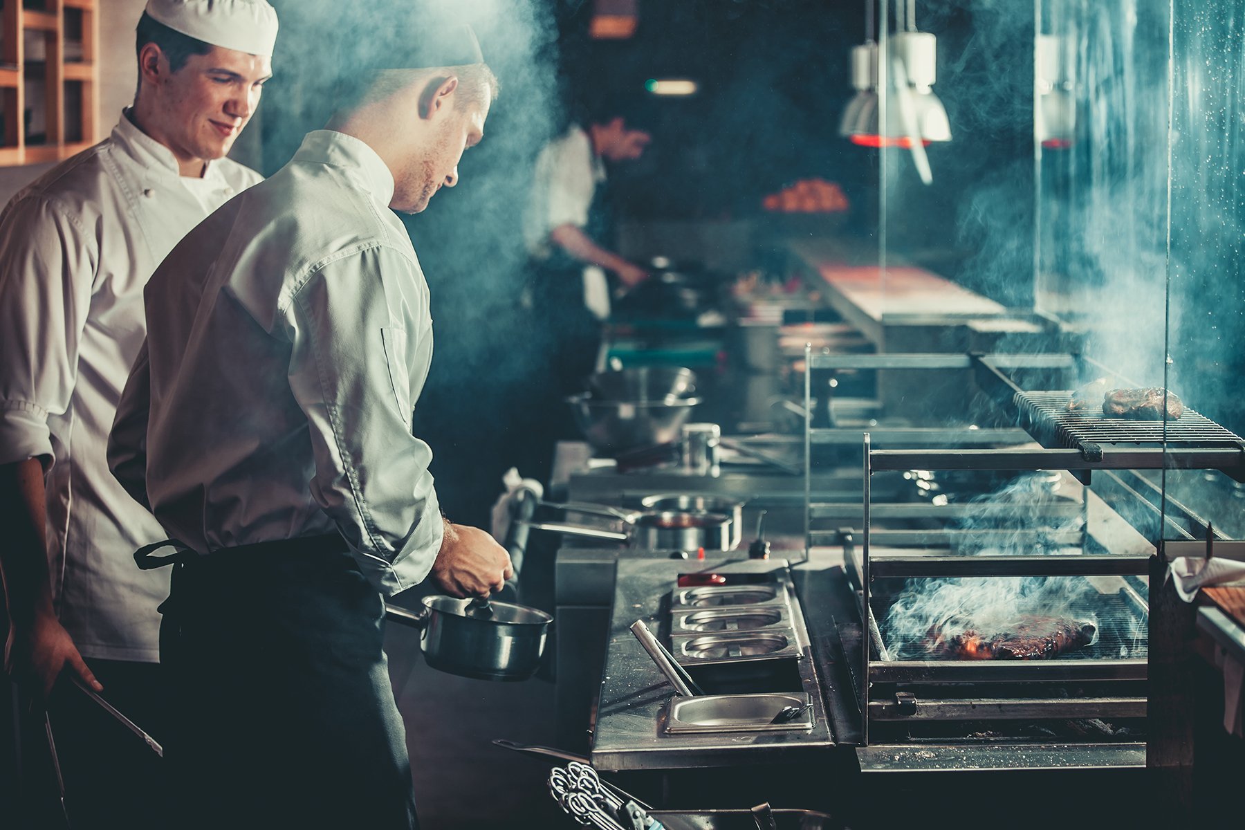 Professional chefs cooking in a commercial kitchen