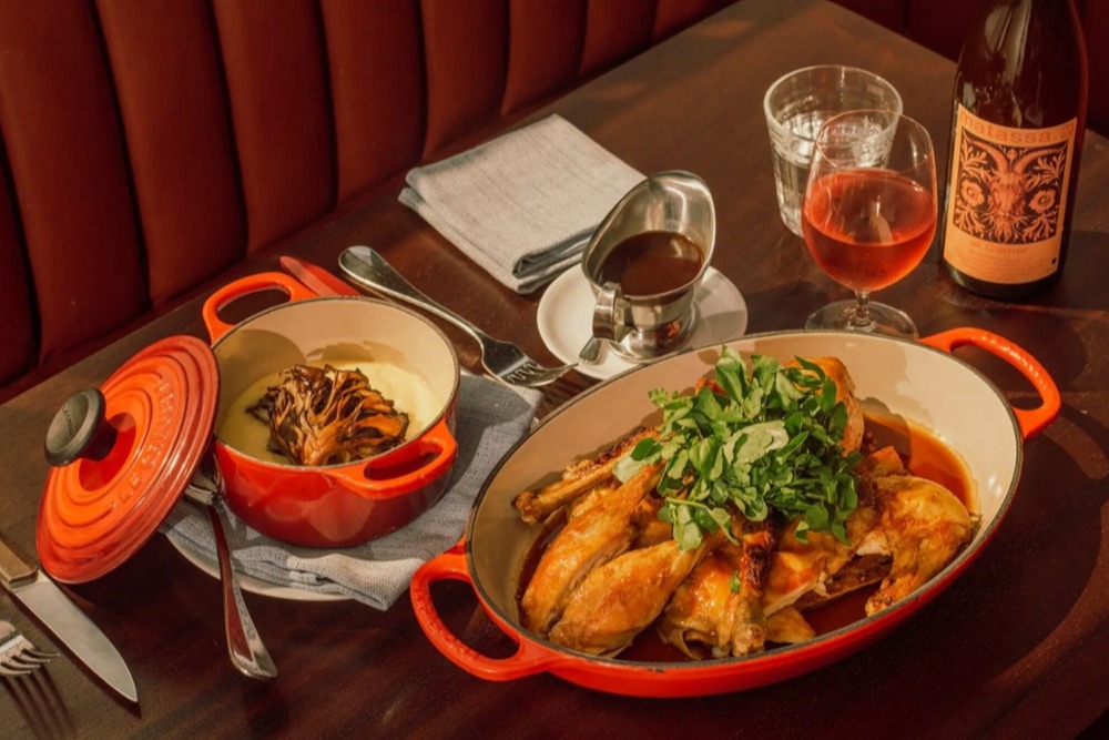 close up of thanksgiving dinner components in pans and pots at a restaurant table