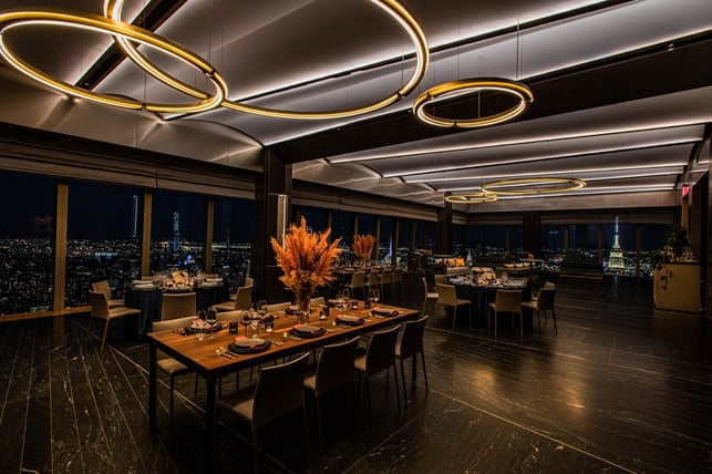 tables at the restaurant with a 360 view of NYC from their large glass windows
