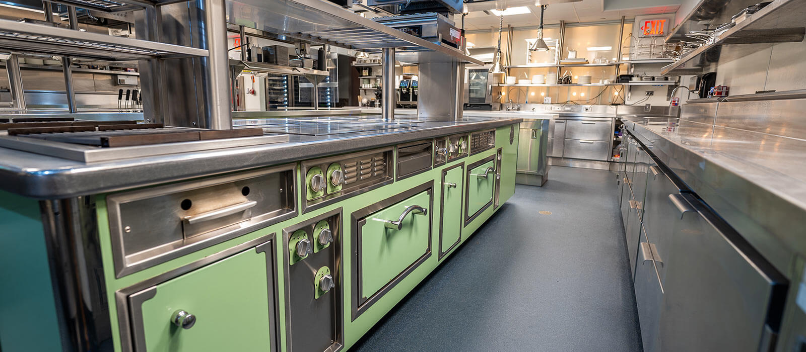 LeRock restaurant kitchen with green cabinetry and stainless steel
