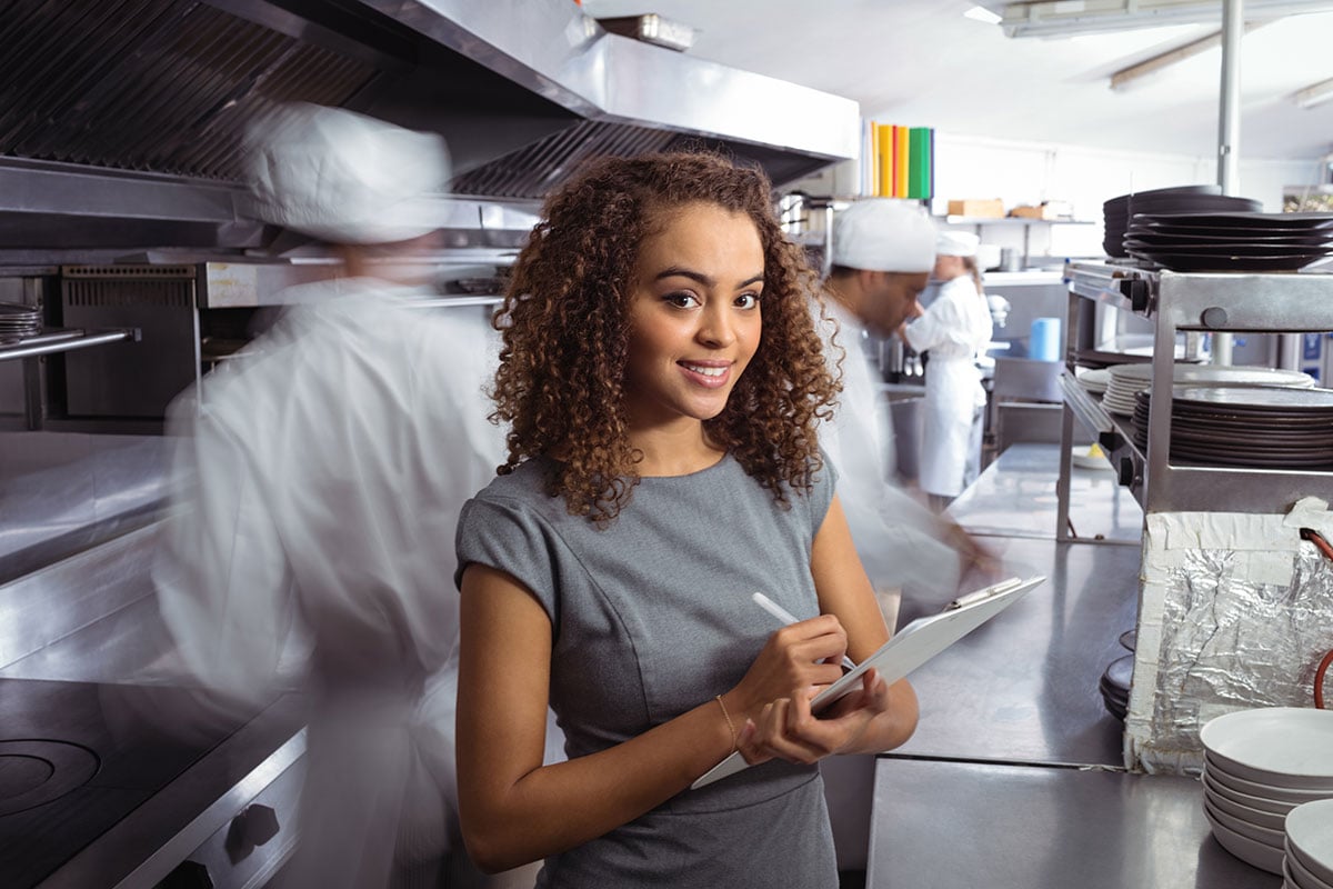 African American Woman taking inventory of kitchen supplies