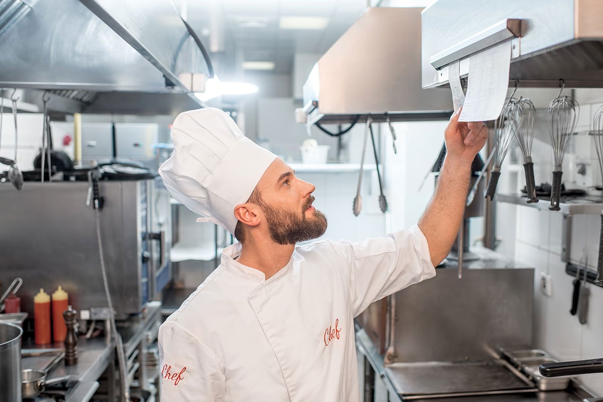 Kitchen Chef checking order meal ticket
