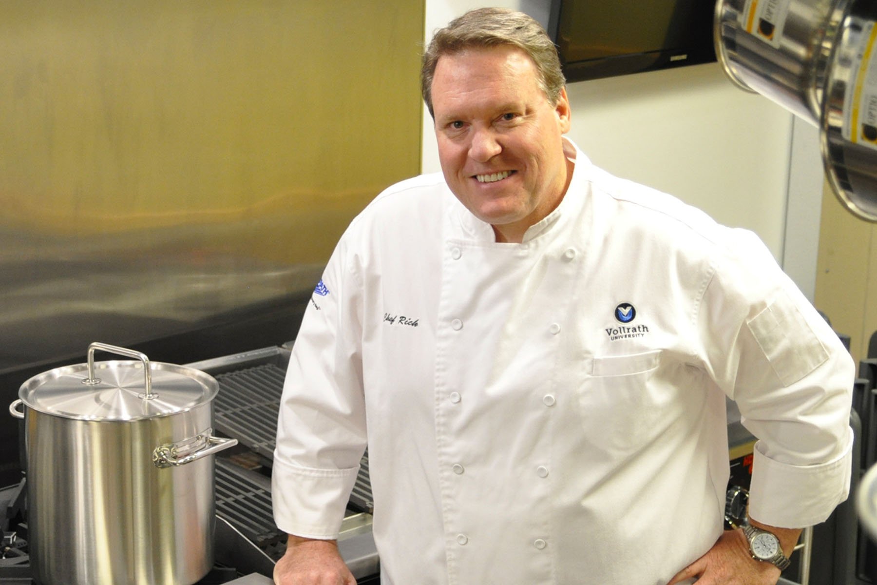 Chef Richard Rupp in the kitchen with a pot on a stove next to him