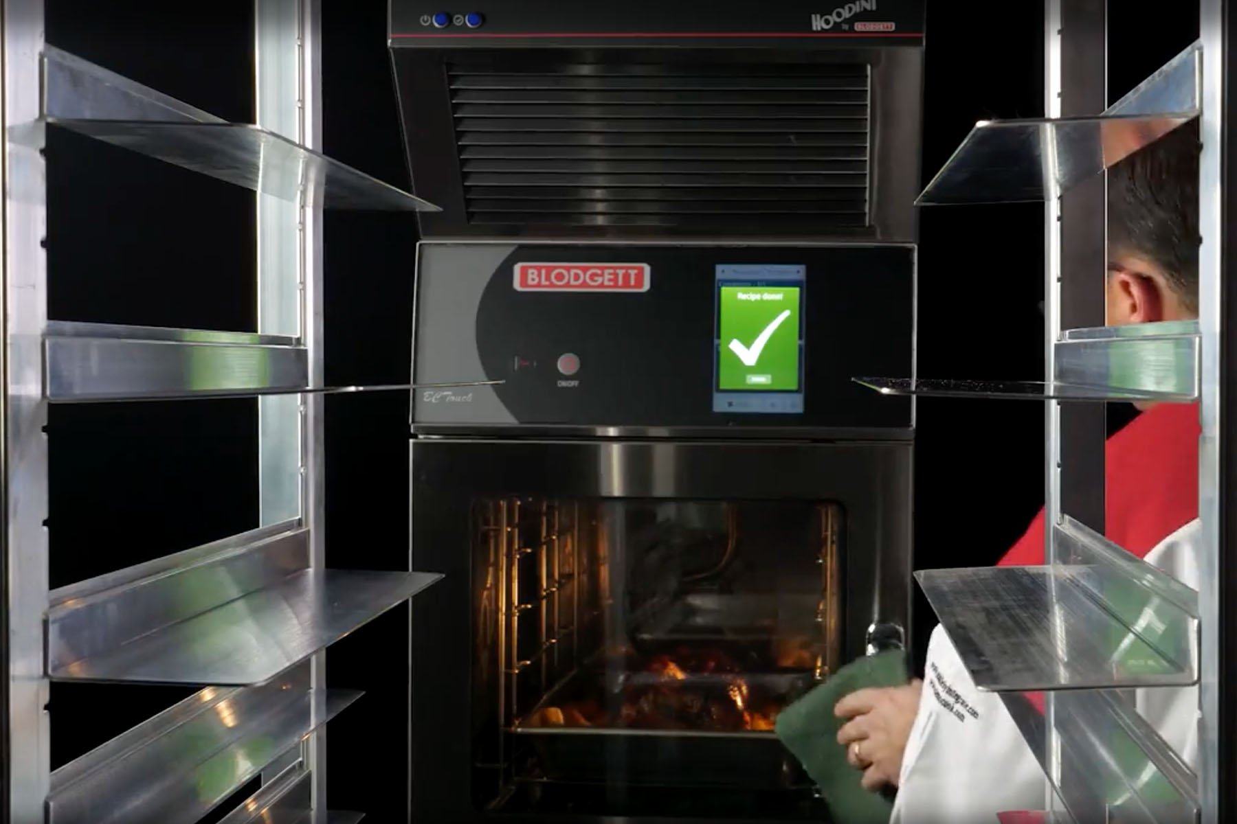 Interior of commercial combi oven with chef opening the oven door