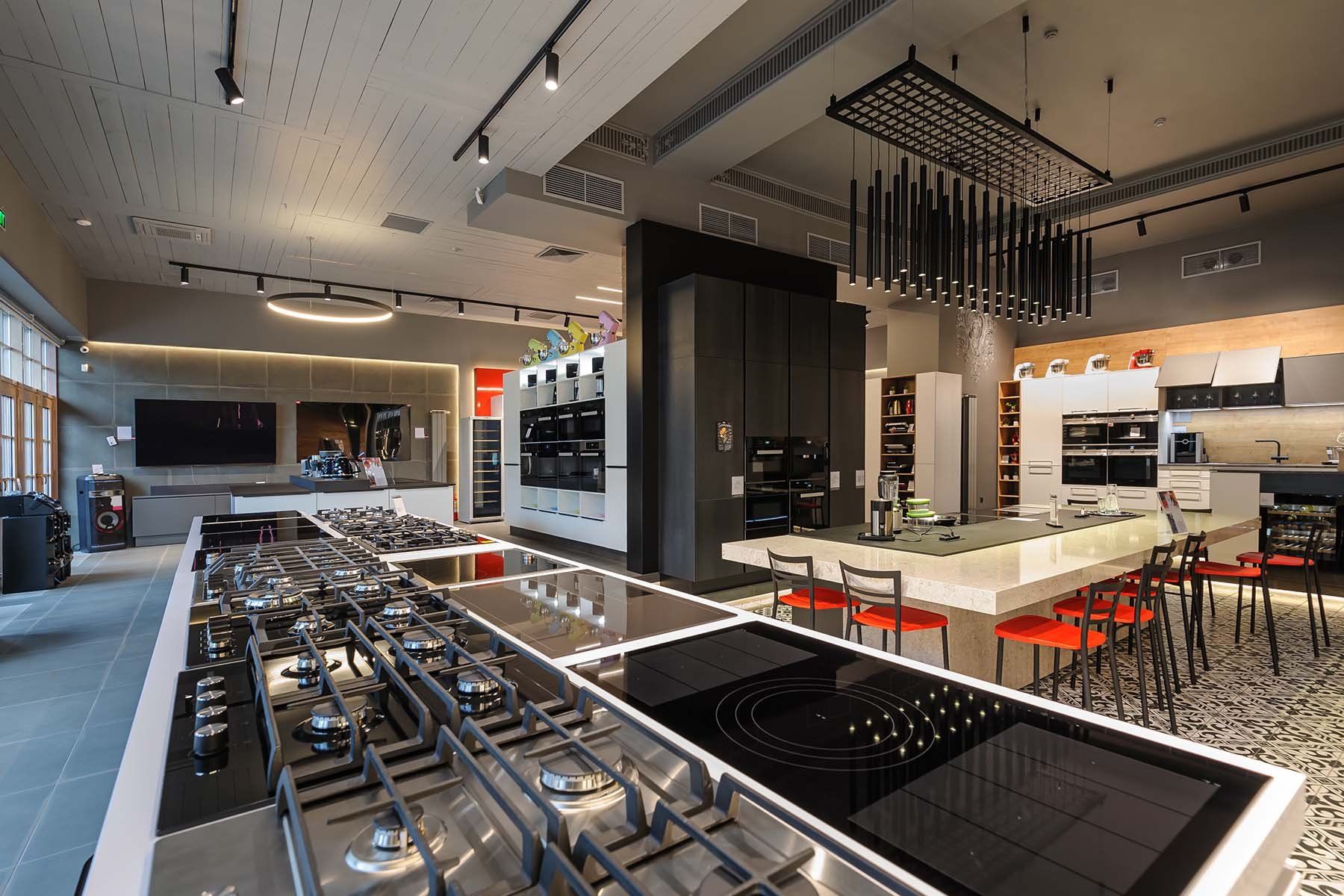 industrial kitchen with both induction cooktop and gas burners