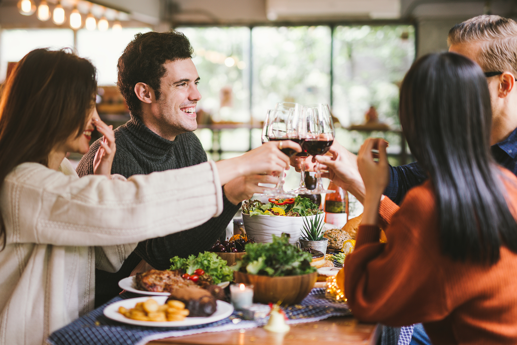 Friends enjoying fall thanksgiving type dinner in restaurant