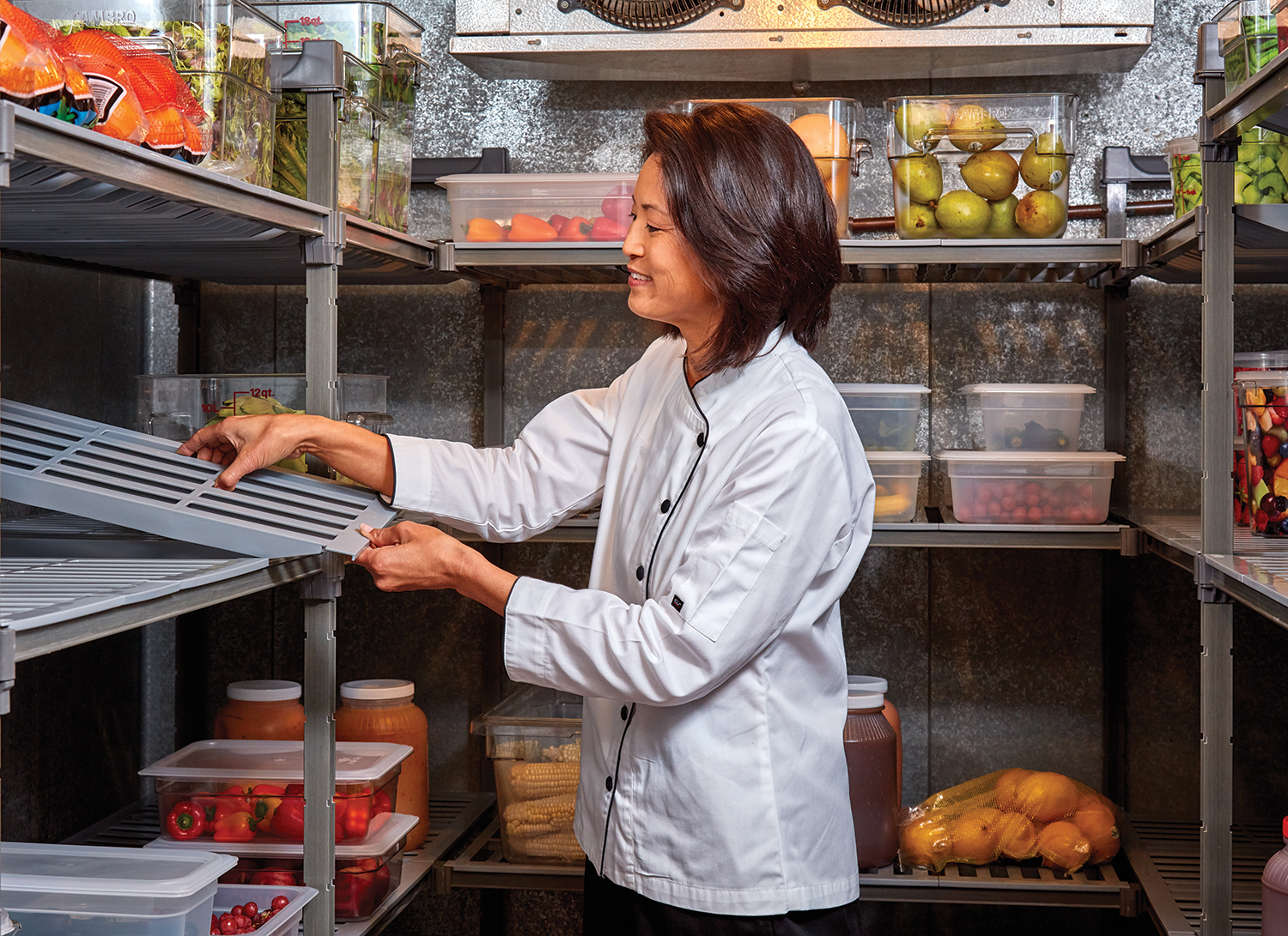 Chef using camshelving in walk-in fridge